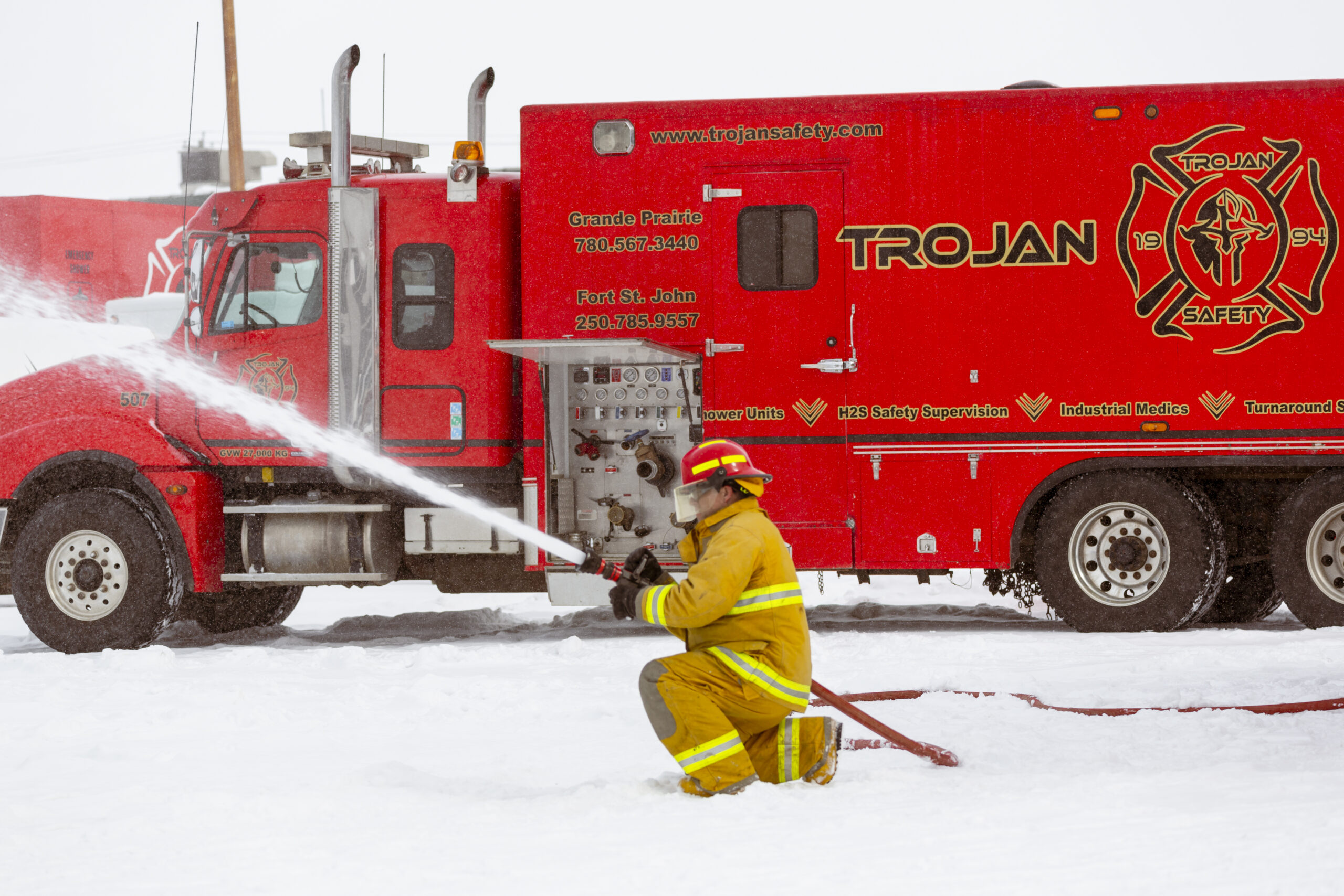 Firefighter using a fire hose