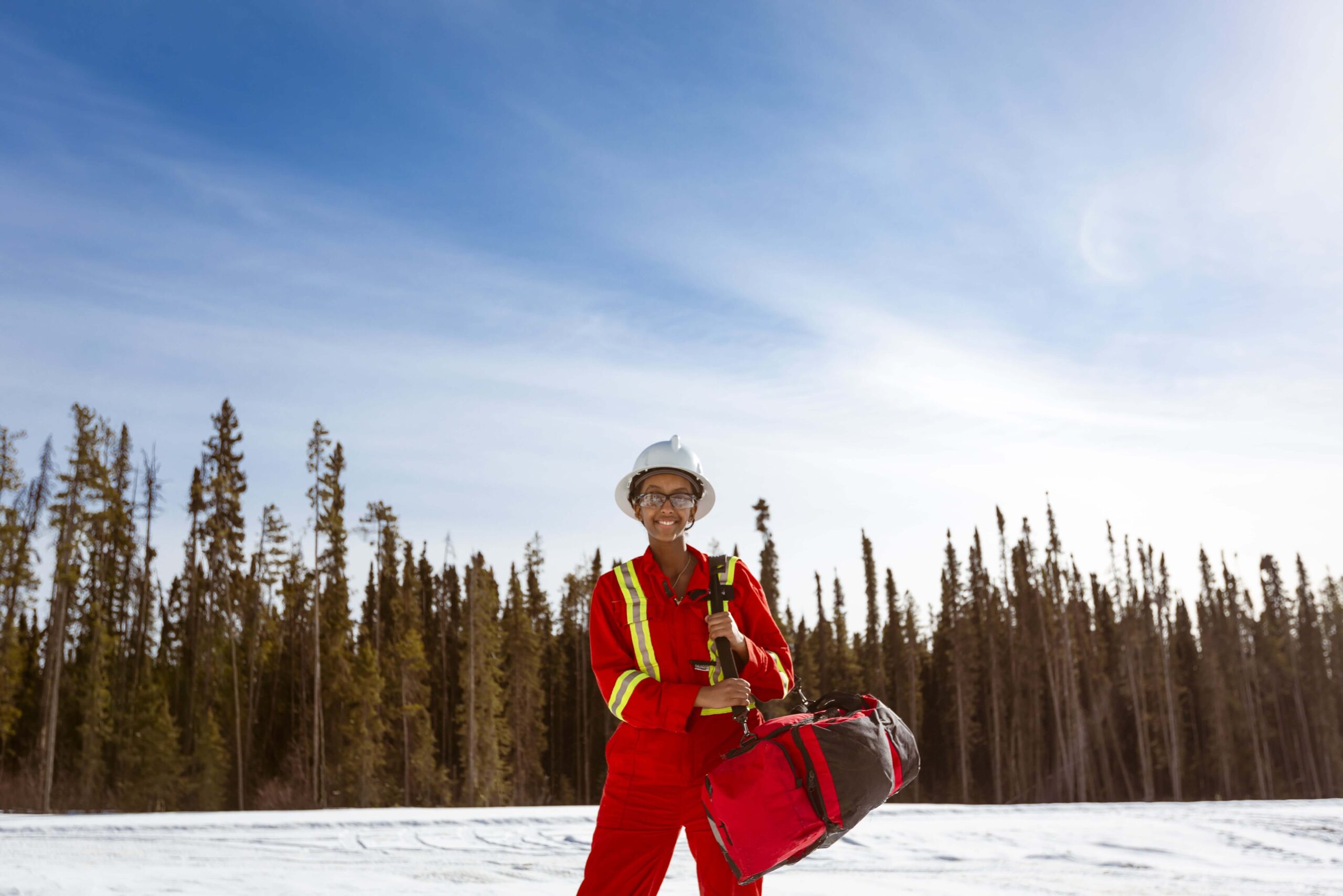 Person carrying an emergency bag in a rural area.