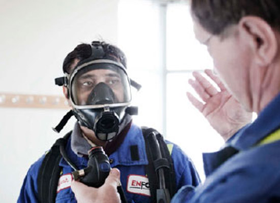 A worker wearing a self contained breathing apparatus.