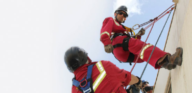 Two trainers repelling during fall arrest training.