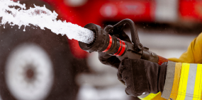 Firefighter using a fire hose.