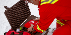 A worker operating an automated external defibrillator.