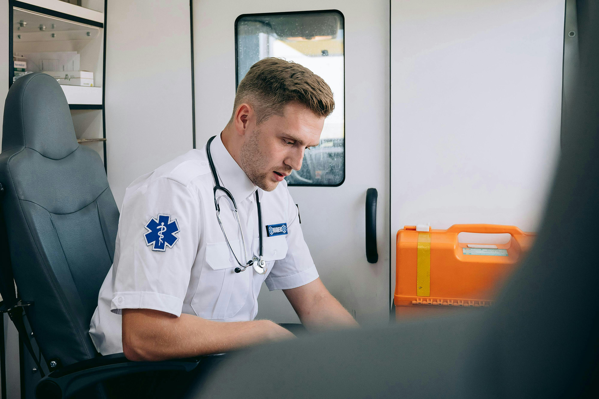 Industrial first aid attendant reviewing supplies before a job interview or remote site assignment.